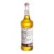 A Monin 750 mL bottle of mango syrup with a label.