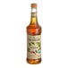 A bottle of Monin Organic Hazelnut Flavoring Syrup with a label.