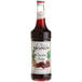 A bottle of Monin chocolate syrup with a white label.