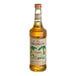A Monin Organic Vanilla Flavoring Syrup bottle with a label.