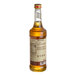 A bottle of Monin Organic Vanilla Flavoring Syrup with a label.