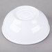 A white Cal-Mil enamelware bowl with a blue rim on a gray surface.