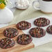 A chocolate cookie with Monin Sugar Free Dark Chocolate sauce drizzled on top.