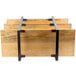 A wooden and metal rack with three shelves on a table.