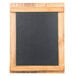 A blackboard in a wooden frame on a table.