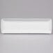 A rectangular white porcelain platter with a long edge.