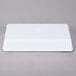 A white rectangular melamine tray with a blue circle on the rim.
