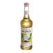 A bottle of Monin French Vanilla syrup with a white label.