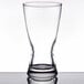 A Libbey customizable rim tempered pilsner glass on a table.