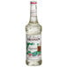 A bottle of Monin Premium Peppermint Flavoring Syrup with a white label.