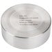 A stainless steel round metal container with a label that says "Cal-Mil" on a table.