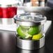 A Cal-Mil chilled condiment organizer with limes and a notched lid.