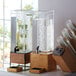 A Cal-Mil Madera rustic pine drip tray under a glass water dispenser.