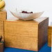 A bowl of cherries on a Cal-Mil rustic pine square riser.