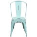 A distressed blue metal chair with a slat seat and back.