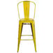 A Flash Furniture yellow metal bar stool with vertical slat back.