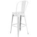 A white metal Flash Furniture bar stool with a vertical slat back.