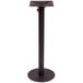 A BFM Seating black metal table base for an outdoor bar table with an umbrella hole.