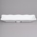 A white rectangular melamine tray with a scalloped edge.