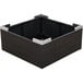 A black square wicker basket with white corners on a table outdoors.