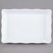 A white rectangular tray with a scalloped edge.