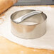 A metal American Metalcraft dough cutter in use on dough.