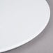 An Elite Global Solutions white melamine plate on a table.