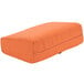 An orange rectangular cushion with a zipper on it.