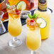 Two glasses of Finest Call Mai Tai with limes and mint on a bar table.