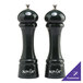 A Chef Specialties Autumn Hues forest green pepper mill and salt mill set on a counter.