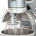 An Avantco mixer with a bowl guard over a metal bowl.