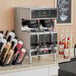 A Curtis Gemini Twin coffee machine on a counter in a corporate office cafeteria.