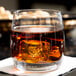 A Spiegelau Vino Grande rocks glass filled with whiskey and ice.