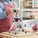 A man using a Garde DC14 vegetable dicer to cut onions on a cutting board.