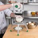 A person using a Garde XL Heavy-Duty Large Vegetable Dicer to cut white onions.