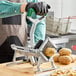 A person using a Garde Heavy-Duty French Fry Cutter to cut potatoes.