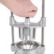 A hand holding the Choice Prep fruit and vegetable wedge cutter.