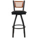 A BFM Seating black metal bar stool with a cherry wood back and black vinyl seat.