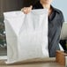 A person holding a white Duro merchandise bag.