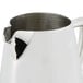 A Vollrath stainless steel open creamer with a handle.