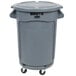 A Rubbermaid grey trash can with wheels and a lid.