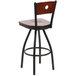 A BFM Seating black metal bar stool with a mahogany wooden backrest.