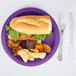 A sandwich on a Creative Converting amethyst purple paper plate with potato chips.