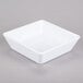 An American Metalcraft white square melamine bowl on a gray surface.