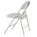 A gray metal folding chair with a gray cushion on the seat.