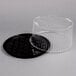 A black plastic D&W Fine Pack cake display container with a clear lid.