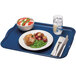 A blue Cambro rectangular fiberglass tray with food, a fork, and a knife on it.