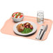 A light peach Cambro rectangular fiberglass tray with food on it.