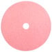 A pink circular Scrubble burnishing pad with a hole in the middle.