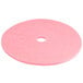 A pink Scrubble burnishing pad with a hole in the middle.